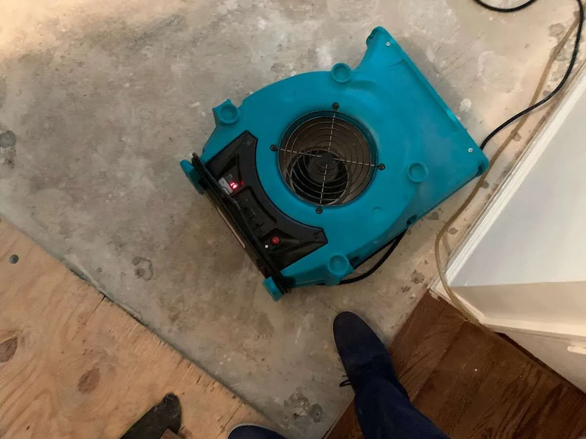 Air mover drying subfloor during Leak Detection & Repair in Upper Makefield